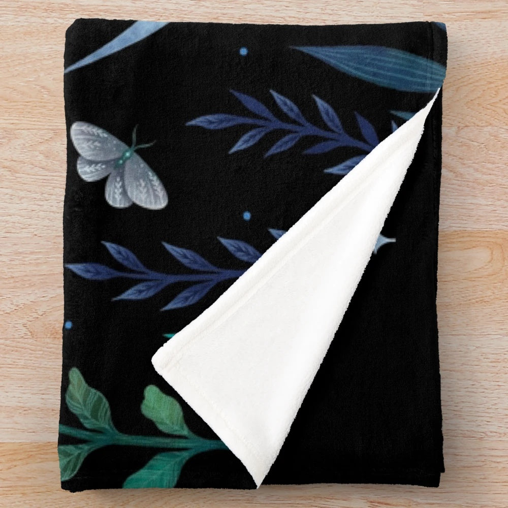 Plush blanket with enchanting moth garden design