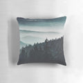 A cozy mountain light pillow with a serene, misty forest landscape design