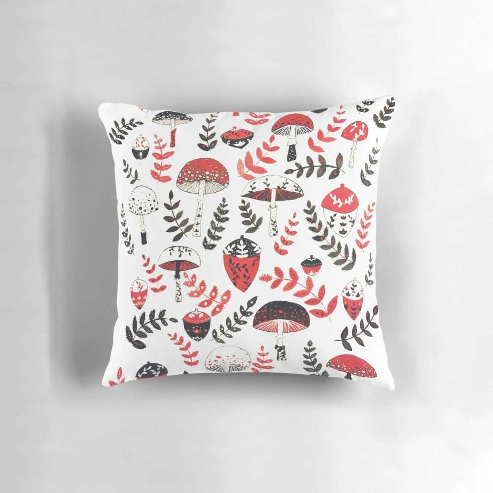 A decorative pillow featuring a whimsical design of magical mushrooms and acorns in a forest setting