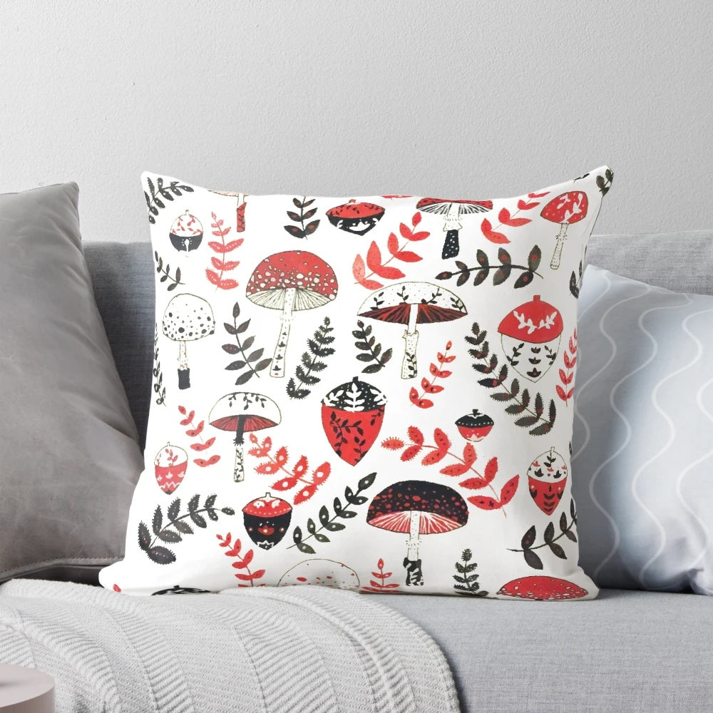 A decorative pillow featuring a whimsical design of magical mushrooms and acorns in a forest setting