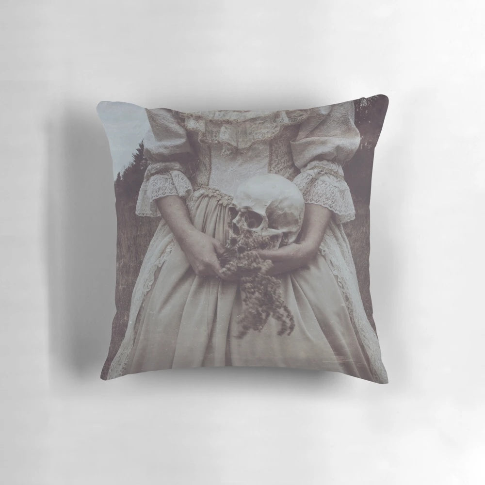 A soft, nature-inspired pillow featuring a delicate pastel skull design, perfect for adding a touch of gothic elegance to any space.