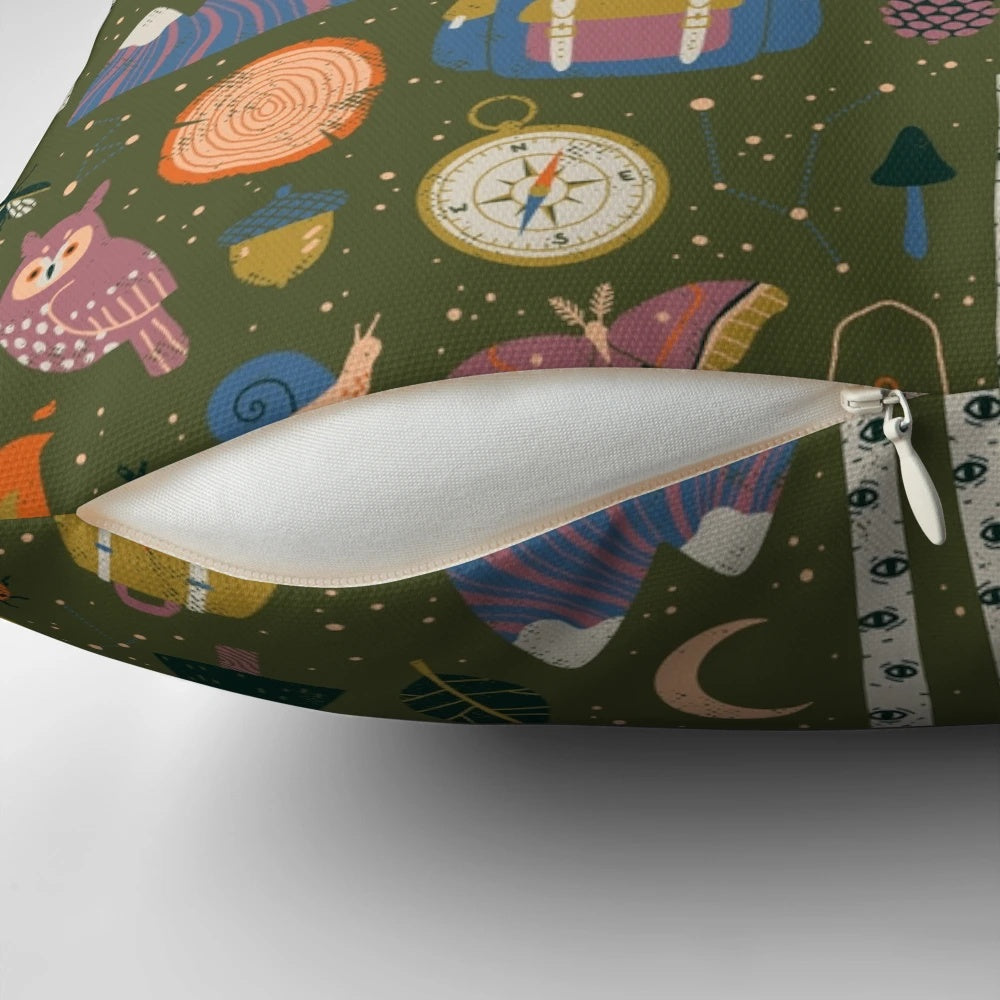 A nature-inspired pillow with a forest design, featuring owls, campfires, and wanderlust elements.
