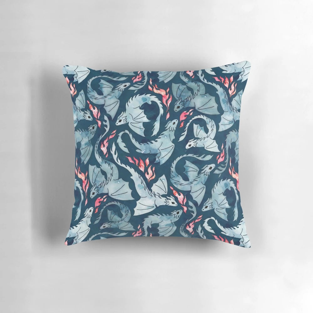 Navy blue pillow with a seamless watercolor design of a cute fire-breathing dragon