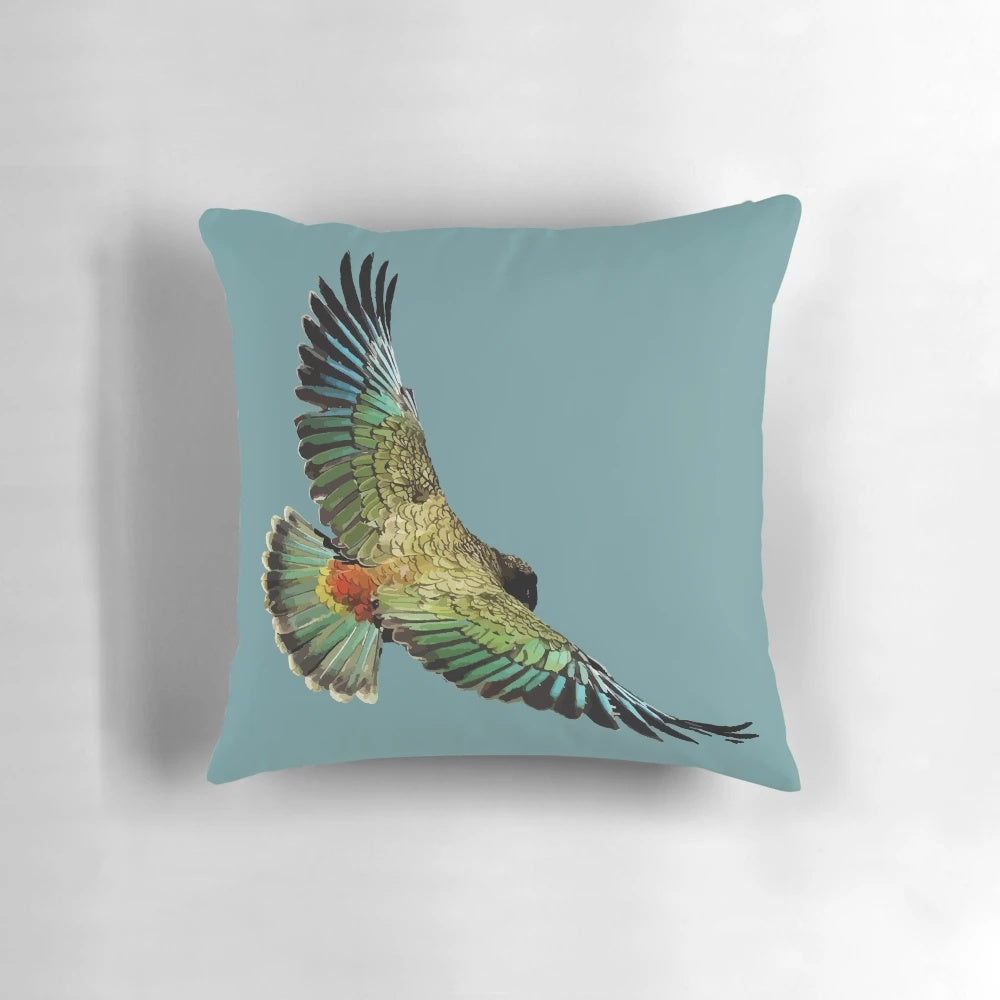 A plush pillow featuring the vibrant colors and unique design of the New Zealand kea, a native alpine parrot.