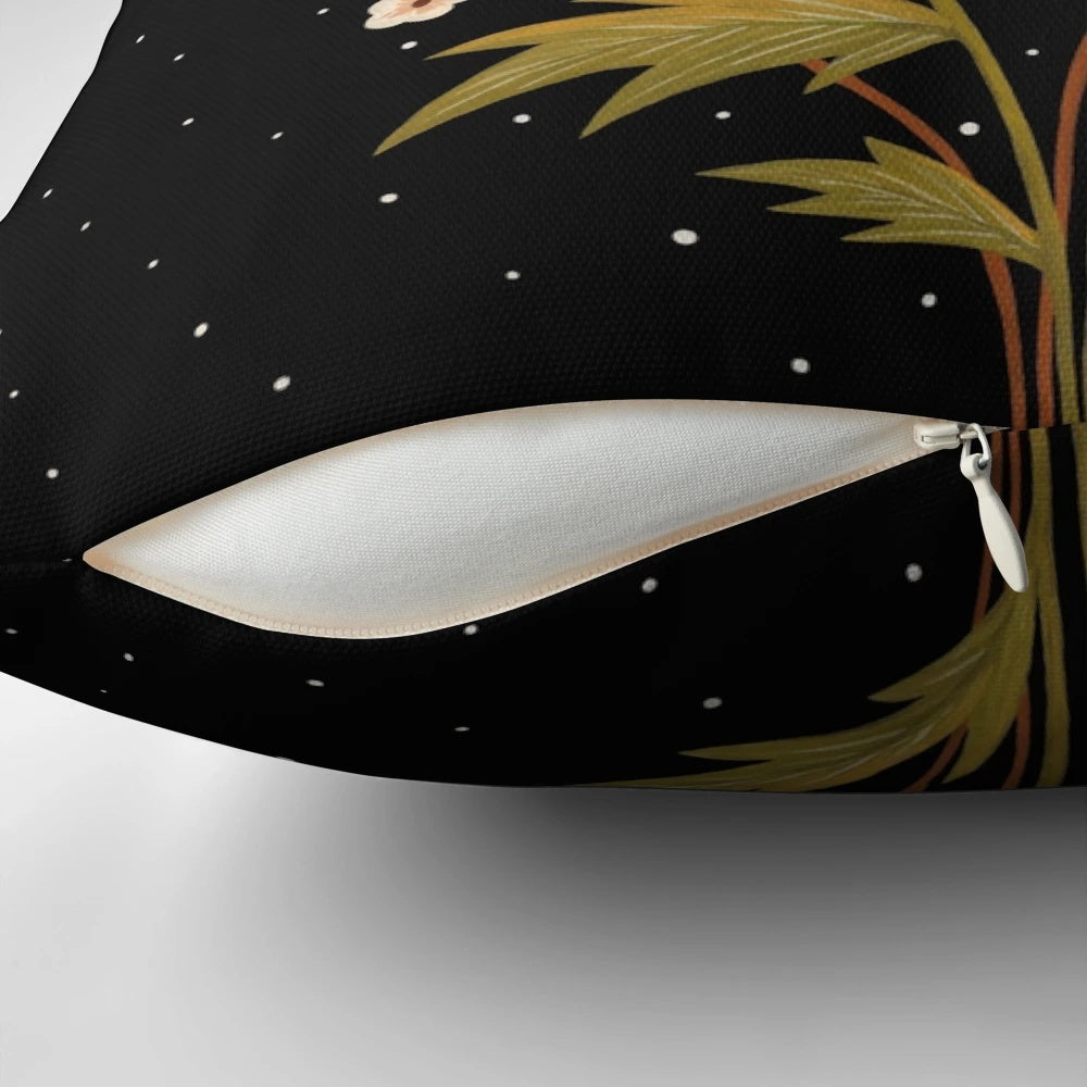 A dark, moody pillow featuring a gouache painting of night blooming flowers and botanicals.