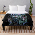 Soft and cozy plush blanket featuring a whimsical moth design against a starry night sky