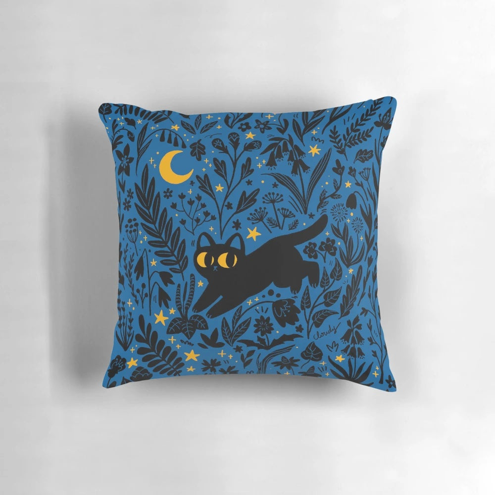 Decorative throw pillow with a whimsical night sky and botanical design featuring a black cat