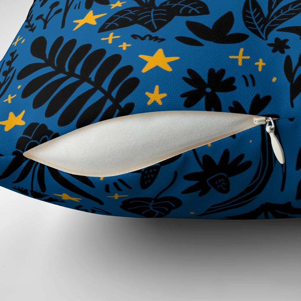 Decorative throw pillow with a whimsical night sky and botanical design featuring a black cat