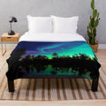 A cozy plush blanket with a stunning northern lights design