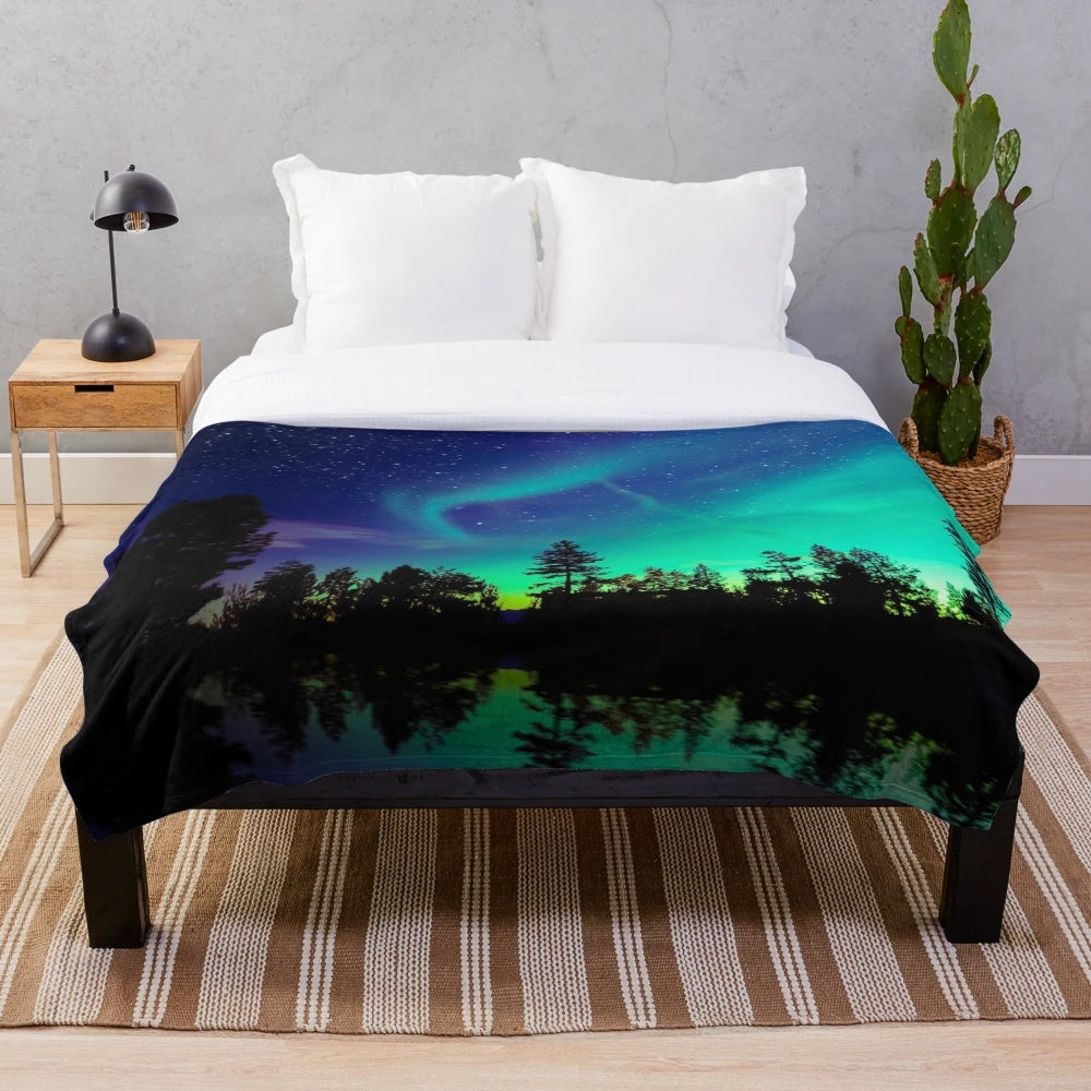 A cozy plush blanket with a stunning northern lights design
