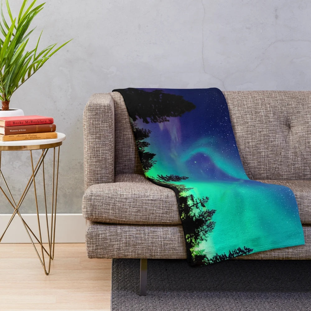 A cozy plush blanket with a stunning northern lights design