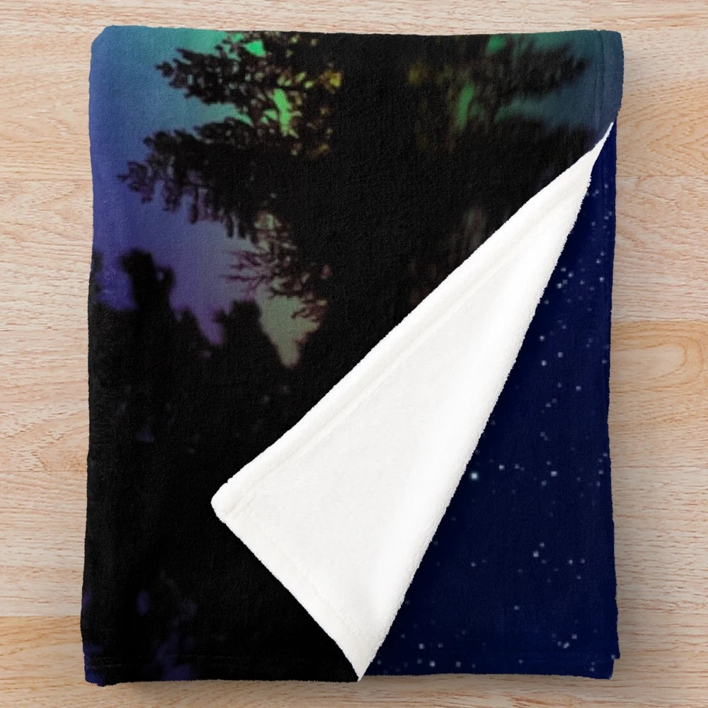 A cozy plush blanket with a stunning northern lights design