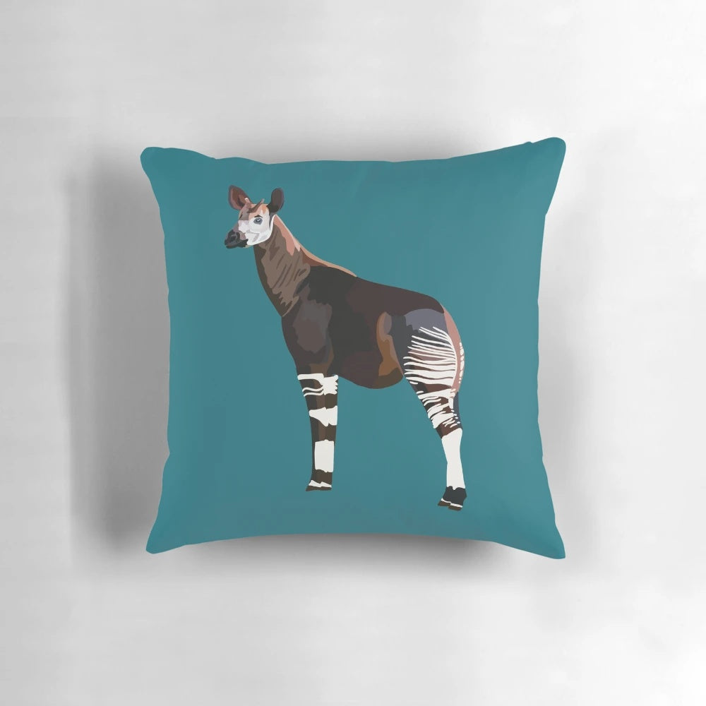 Colorful illustration of an okapi, an endangered rainforest animal, on a soft throw pillow.