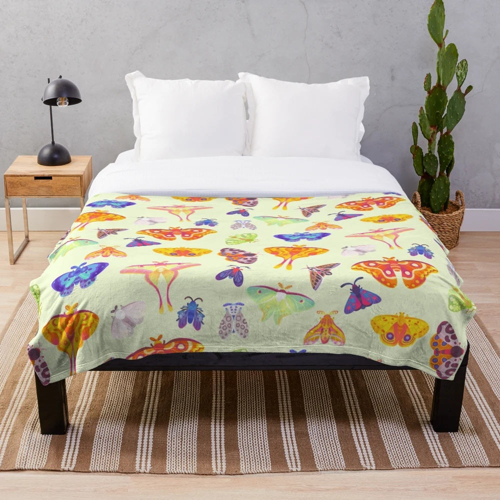 Pastel plush blanket with a captivating luna moth design