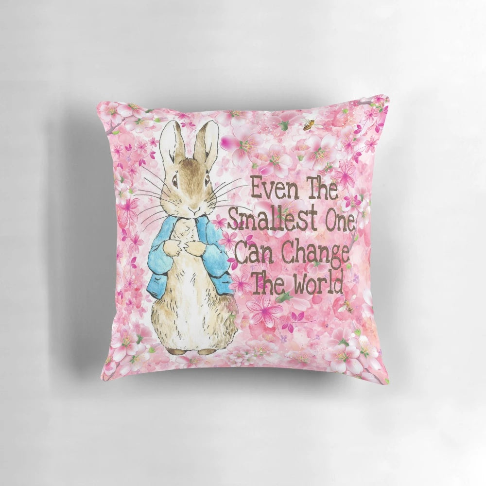 Delicate pink floral pillow featuring the beloved Peter Rabbit character from Beatrix Potter's classic children's books.