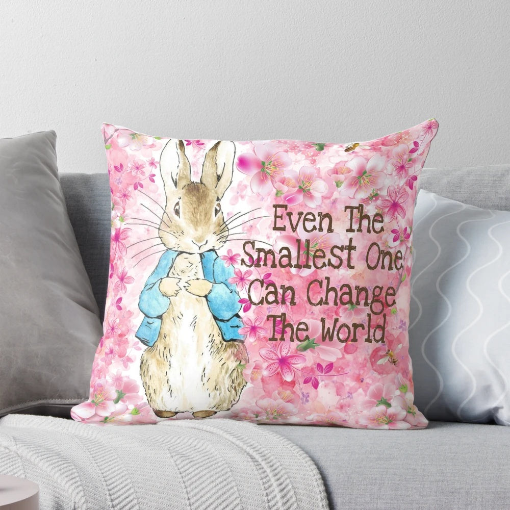 Delicate pink floral pillow featuring the beloved Peter Rabbit character from Beatrix Potter's classic children's books.