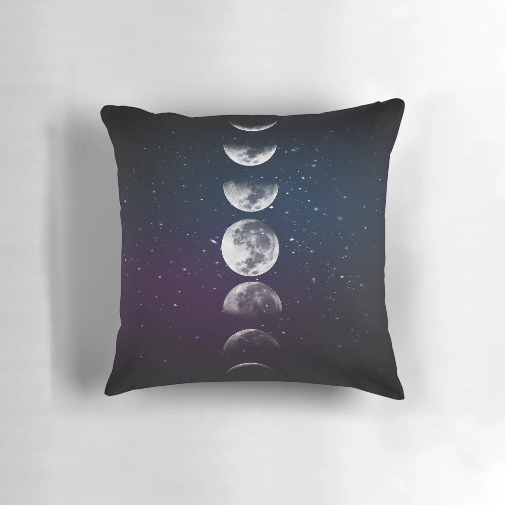 Artistic watercolor illustration of the different phases of the moon on a plush decorative pillow.