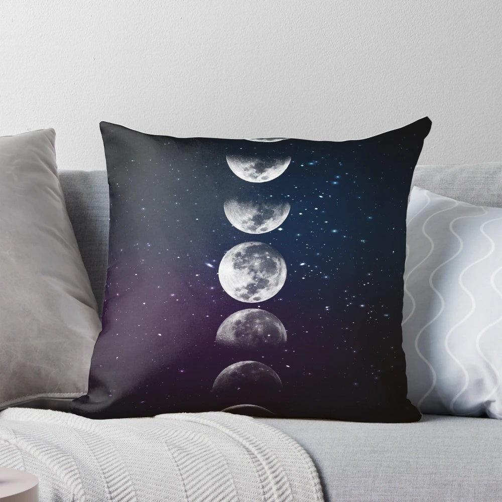 Artistic watercolor illustration of the different phases of the moon on a plush decorative pillow.