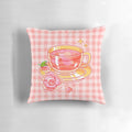 A delightful pixel tea-themed pillow with a pink and floral design, perfect for adding a touch of whimsy to your home decor.