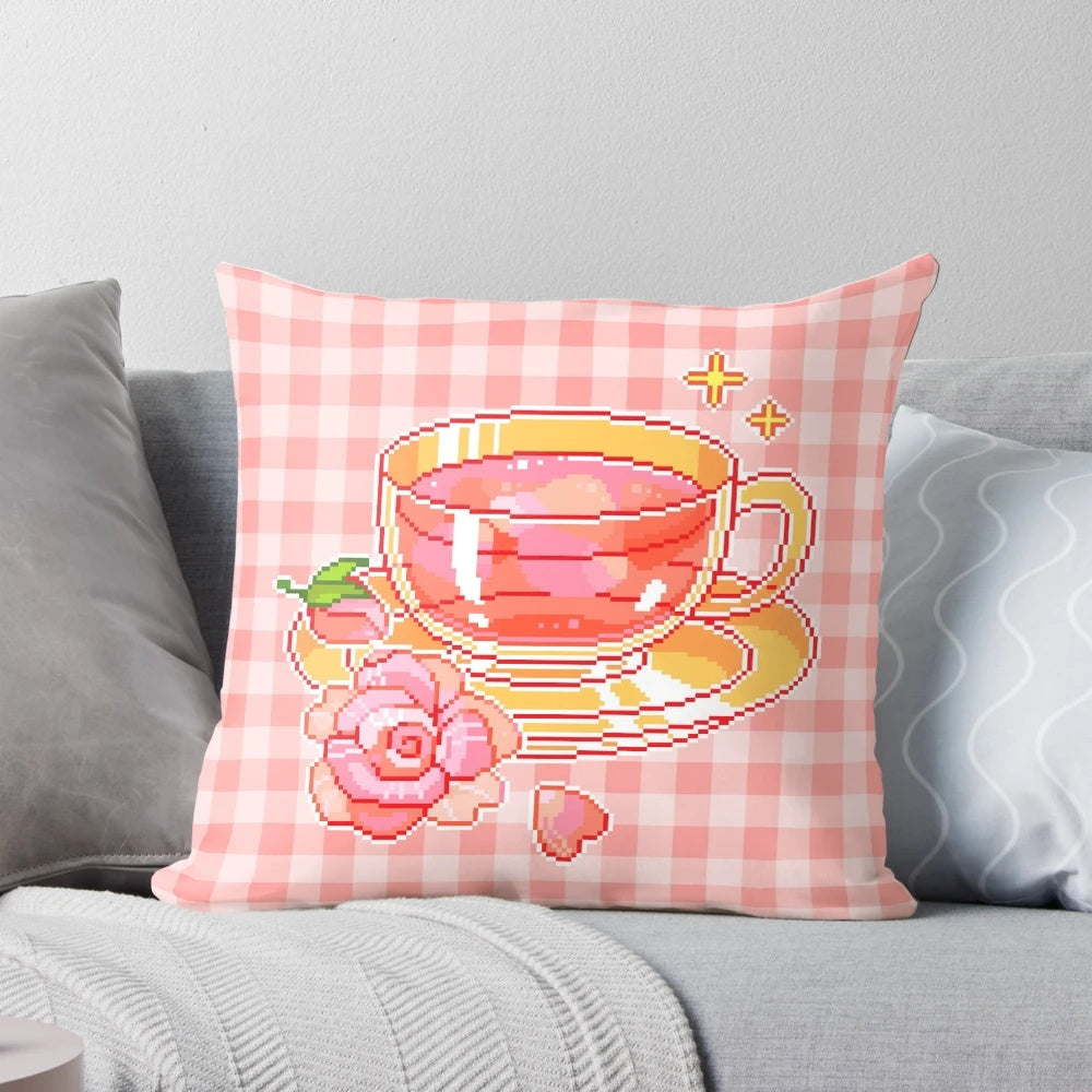 A delightful pixel tea-themed pillow with a pink and floral design, perfect for adding a touch of whimsy to your home decor.
