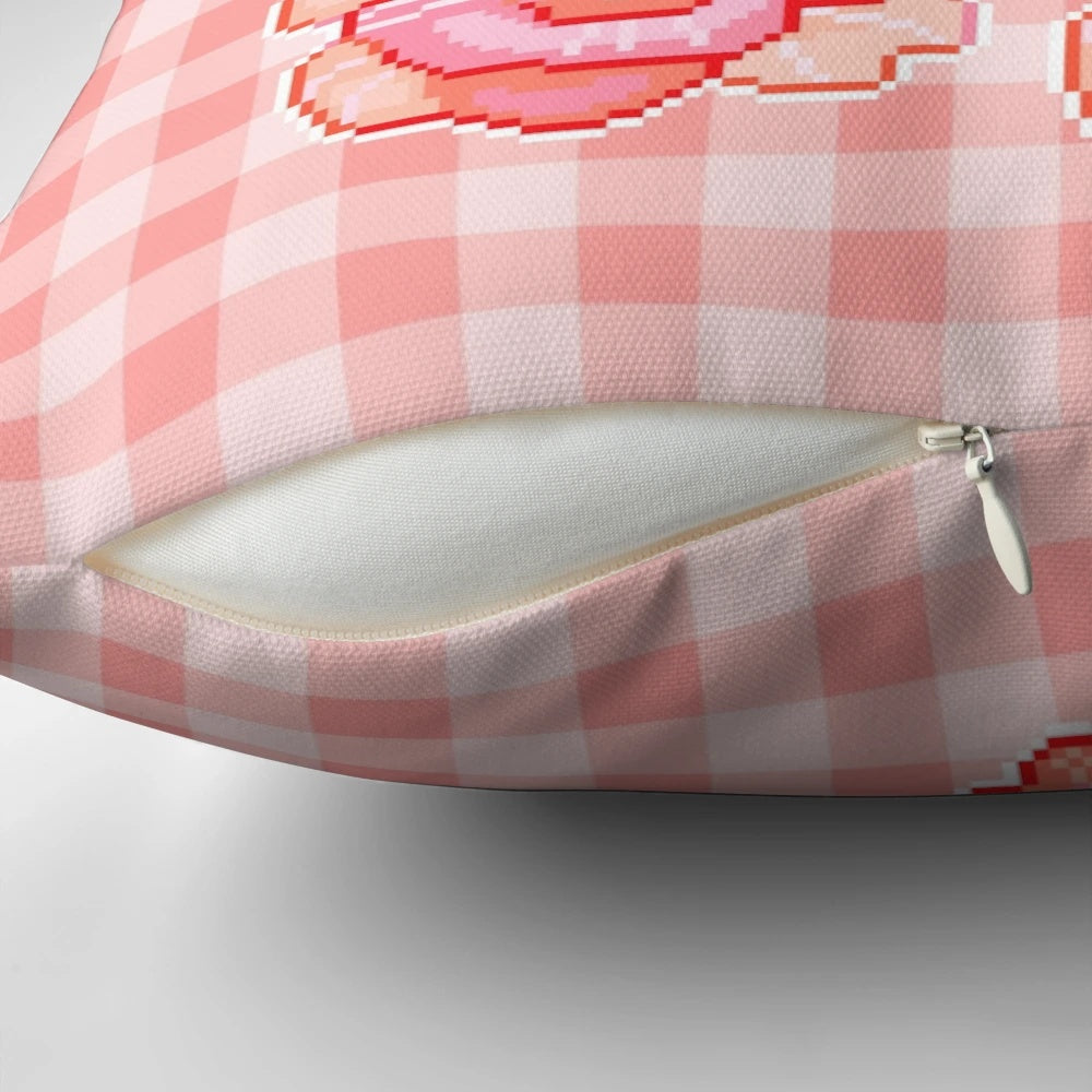 A delightful pixel tea-themed pillow with a pink and floral design, perfect for adding a touch of whimsy to your home decor.