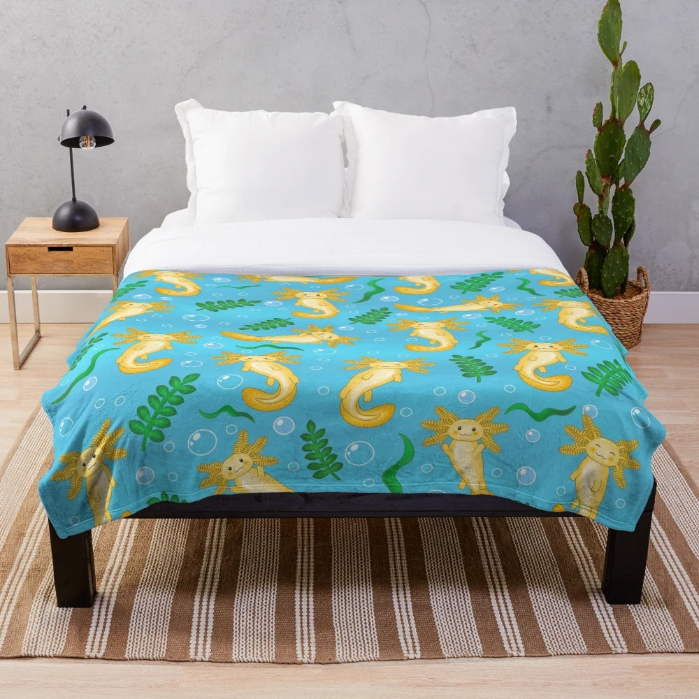 Plush blanket featuring a whimsical pattern of axolotls and other mythical aquatic creatures