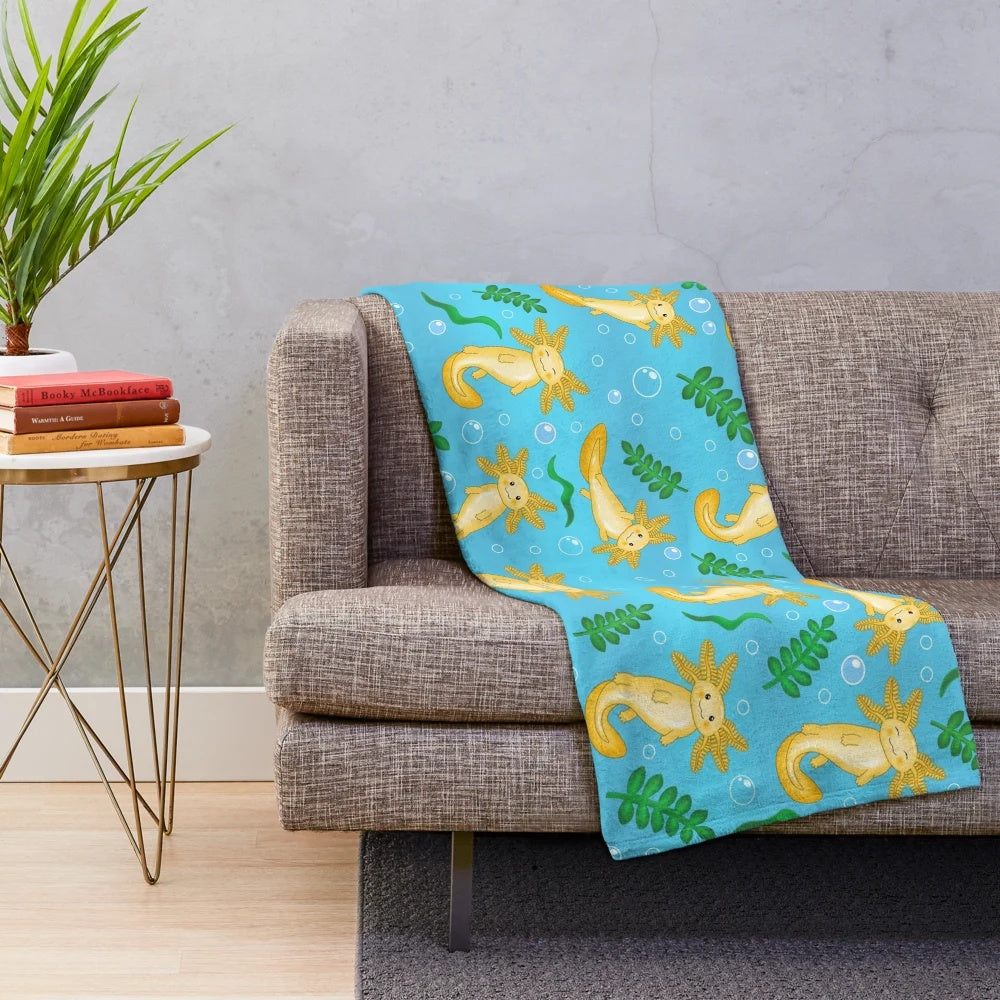 Plush blanket featuring a whimsical pattern of axolotls and other mythical aquatic creatures