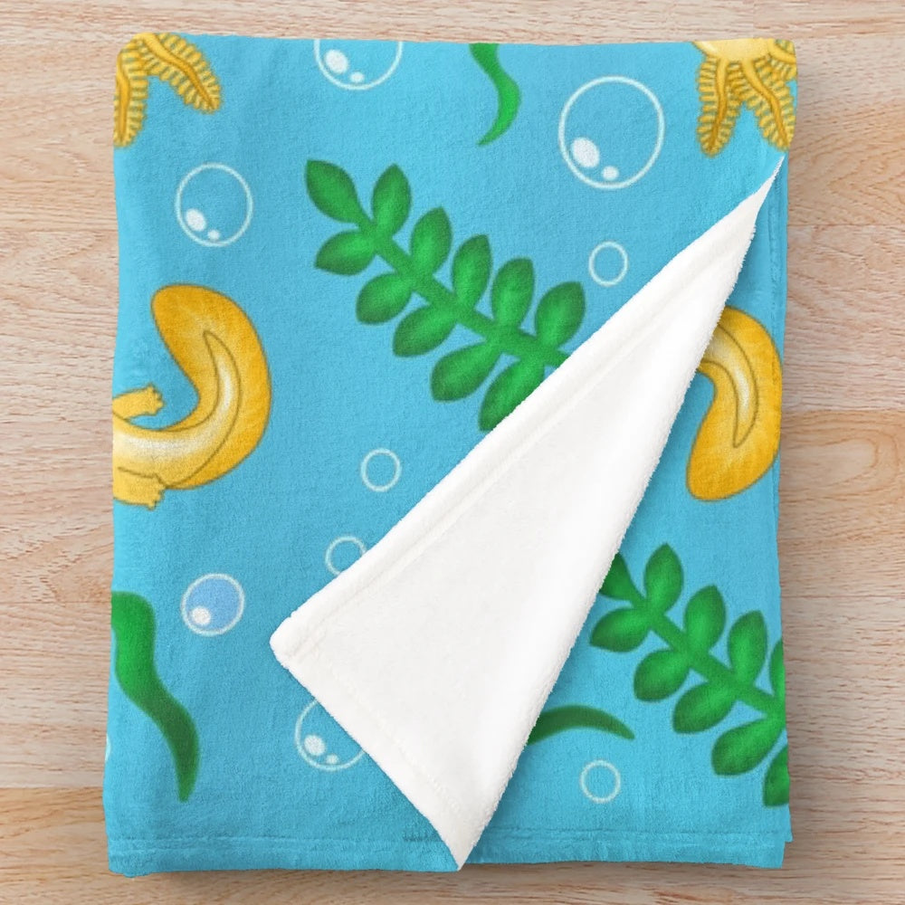 Plush blanket featuring a whimsical pattern of axolotls and other mythical aquatic creatures