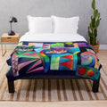Plush blanket with abstract, colorful cats in a moonlit fantasy scene
