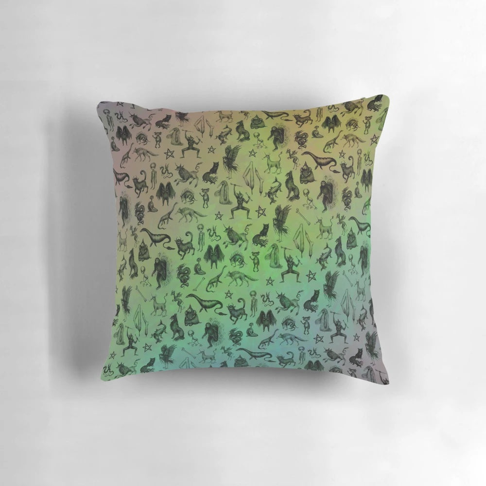 Colorful throw pillow featuring a design of various mythical creatures and cryptids in a rainbow palette.