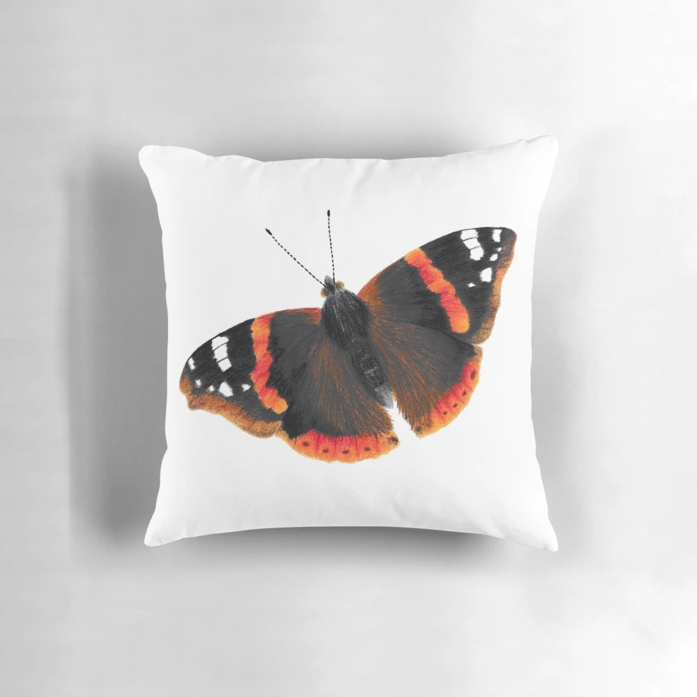 Vibrant red admiral butterfly on a nature-inspired pillow design