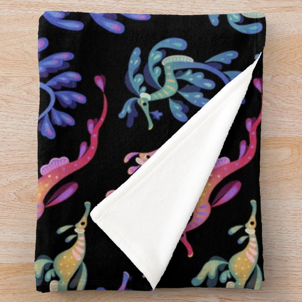 Plush blanket featuring colorful and whimsical sea dragon design