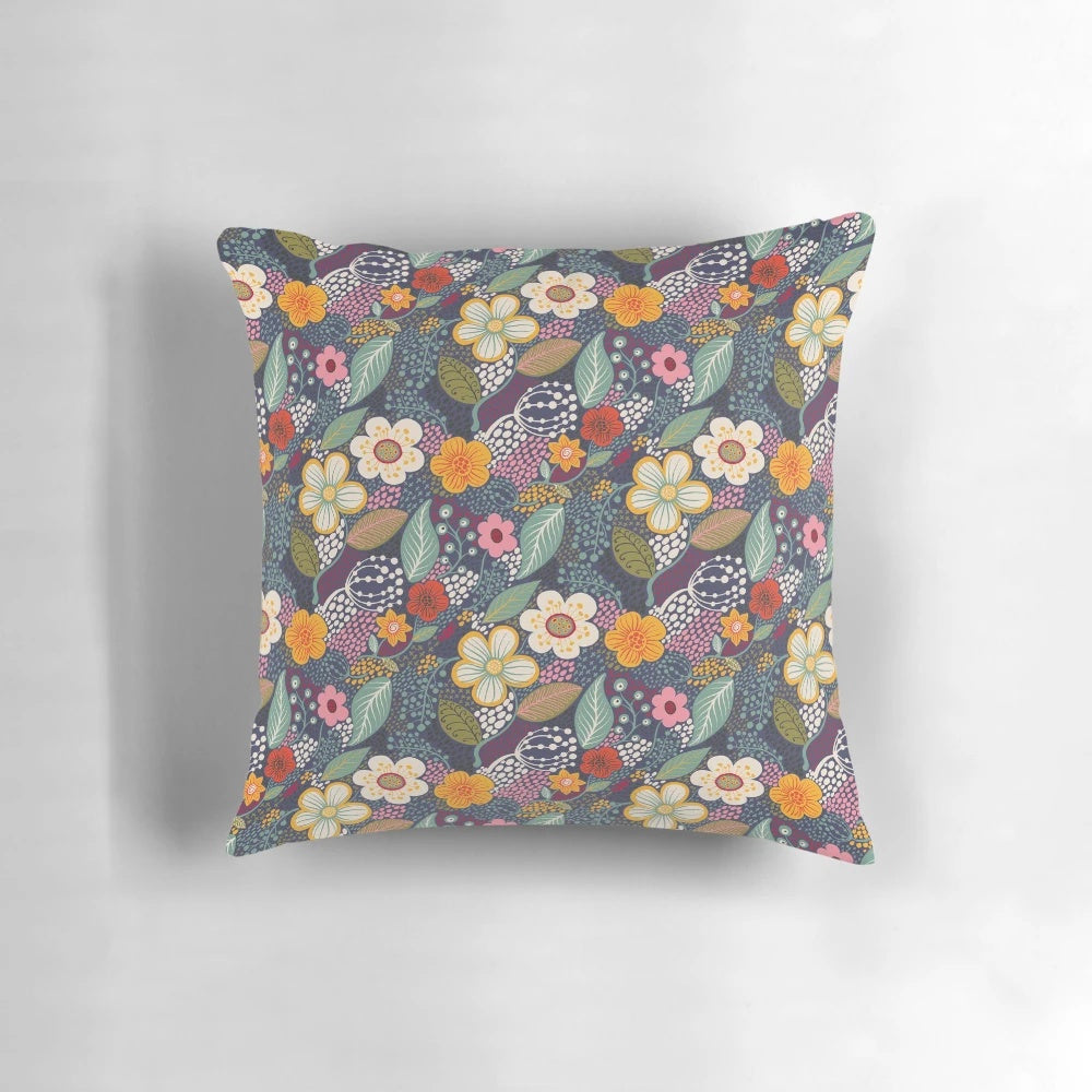 Vibrant floral throw pillow with secret garden-inspired botanical flourishes in navy blue and yellow