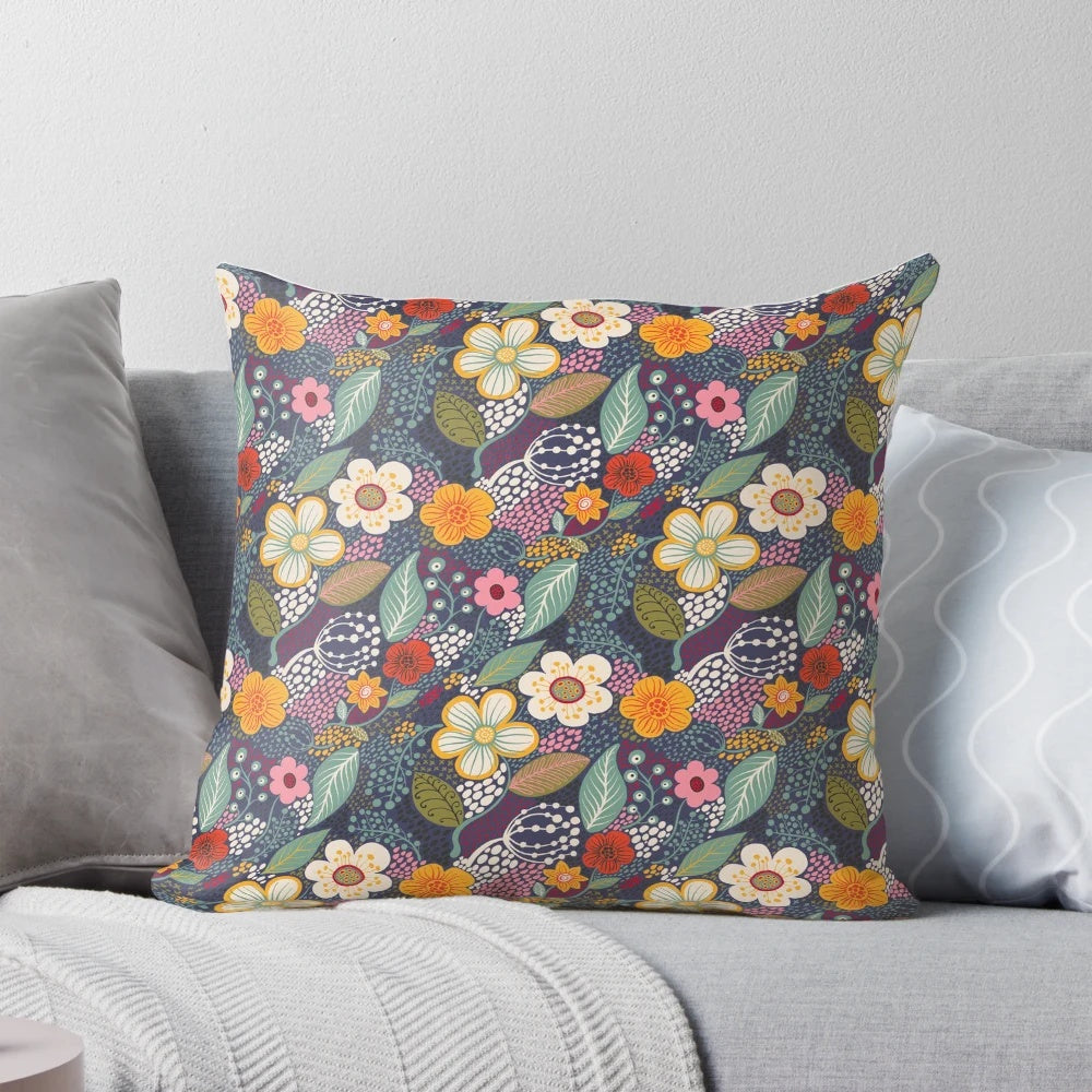 Vibrant floral throw pillow with secret garden-inspired botanical flourishes in navy blue and yellow