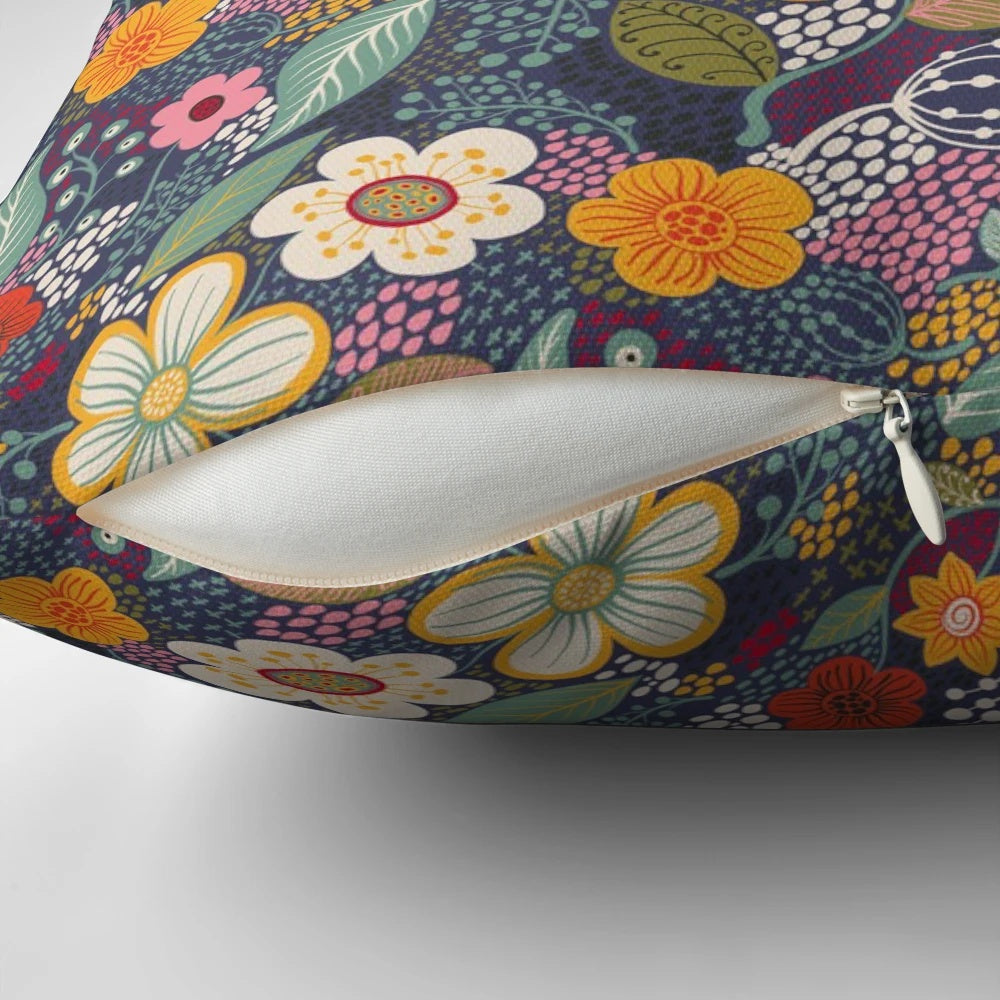 Vibrant floral throw pillow with secret garden-inspired botanical flourishes in navy blue and yellow