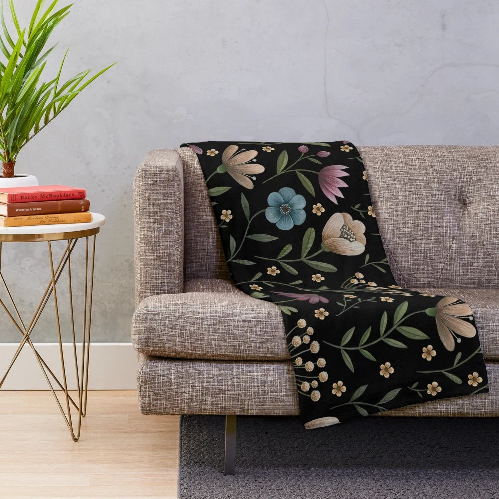 Plush blanket with a beautiful dark floral, botanical pattern inspired by a secret garden