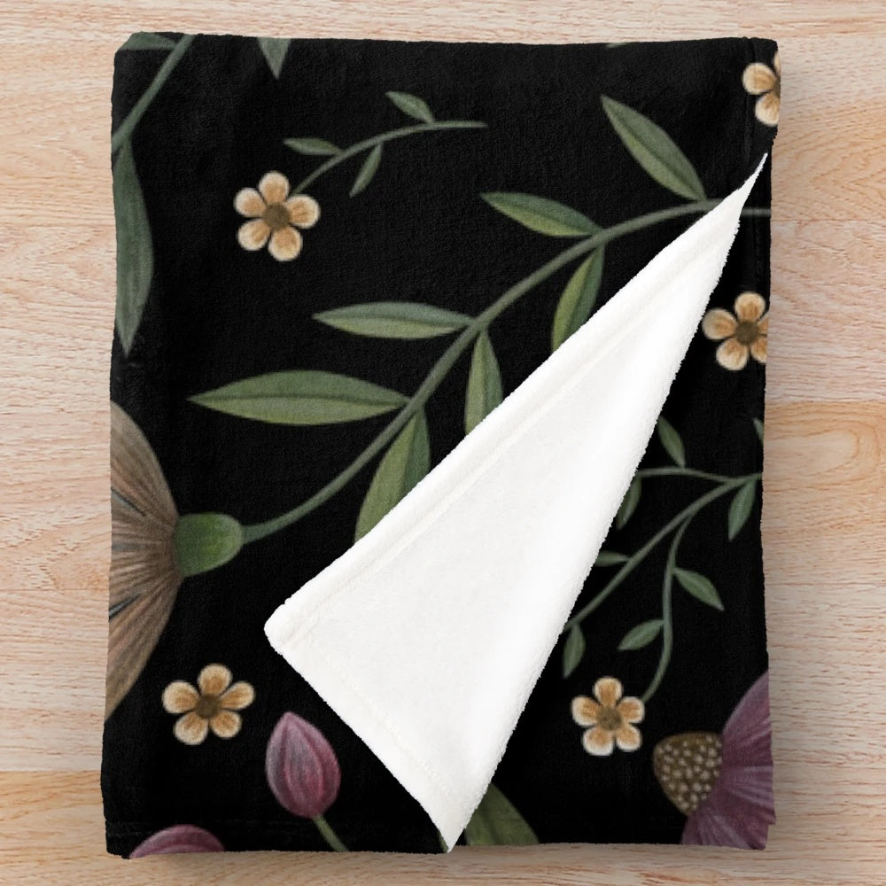 Plush blanket with a beautiful dark floral, botanical pattern inspired by a secret garden