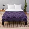 Plush blanket featuring a gothic skull damask pattern
