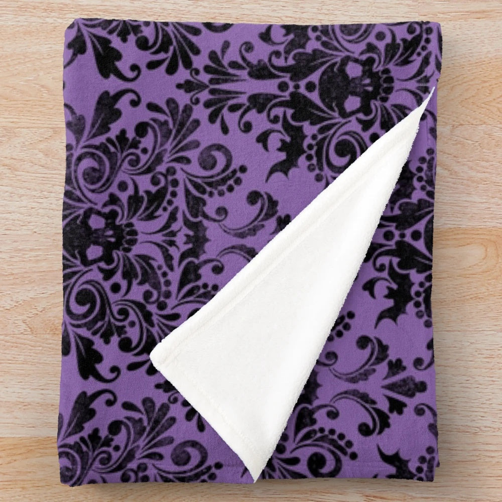 Plush blanket featuring a gothic skull damask pattern