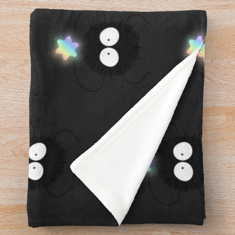 Soot sprite plush blanket with colorful, glowing design
