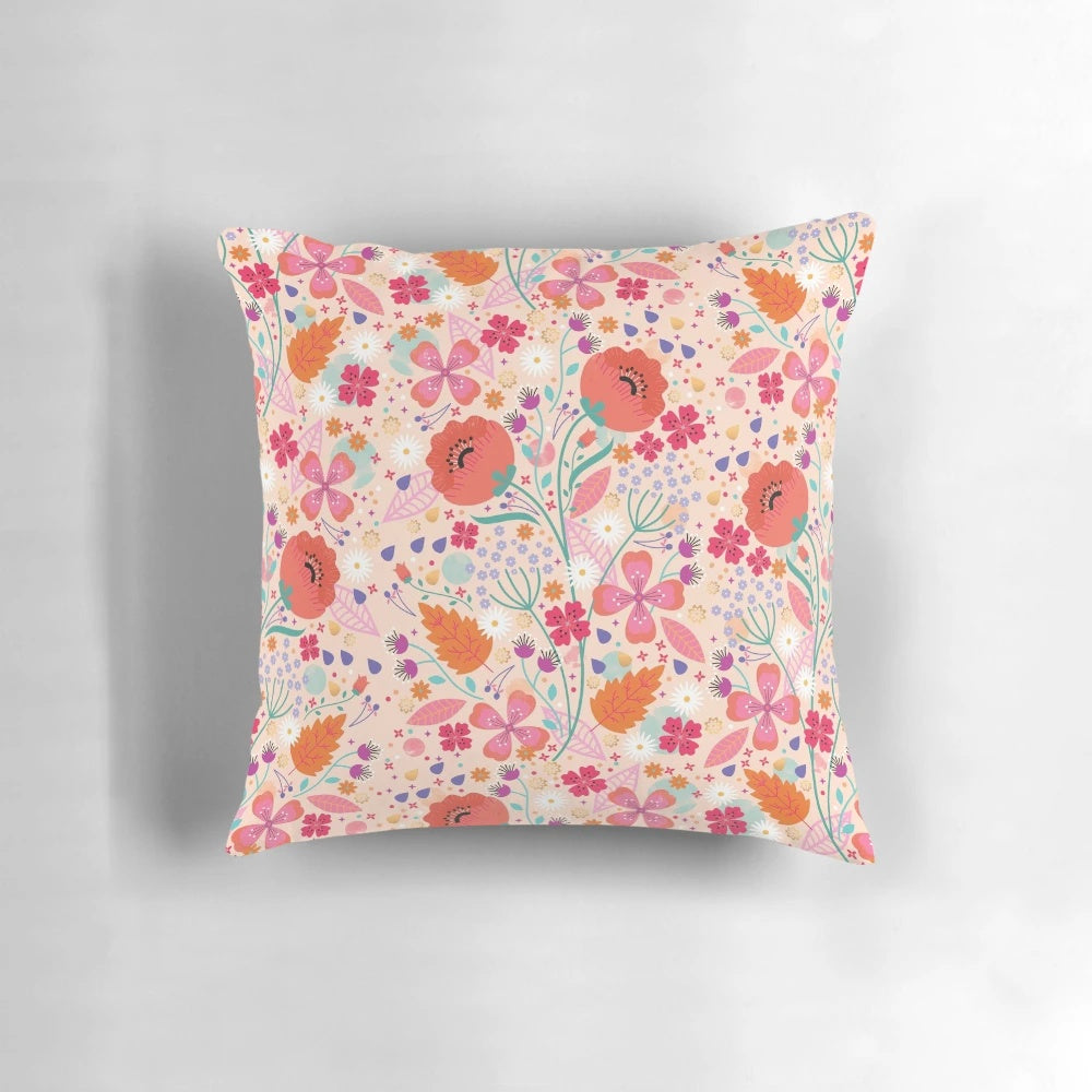 A beautiful spring-themed pillow featuring a floral and leaf design in shades of pink and green