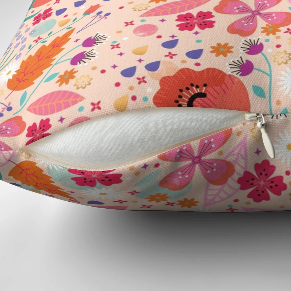 A beautiful spring-themed pillow featuring a floral and leaf design in shades of pink and green