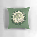 Beautifully illustrated pillow featuring a pair of graceful swans in a lush, green setting