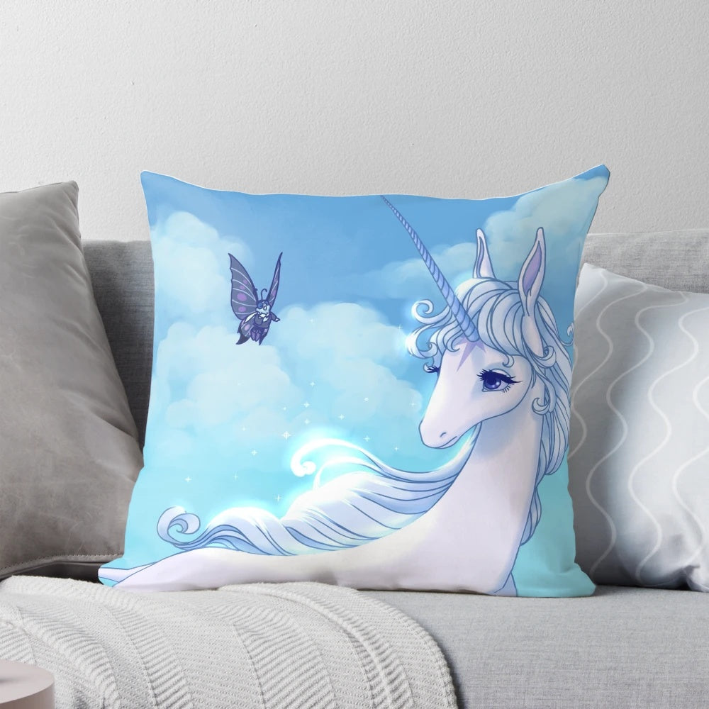 Soft, glowing unicorn pillow featuring characters from the beloved 80s animated film "The Last Unicorn"