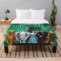 The Wizard Of Oz inspired plush blanket featuring iconic characters and scenes