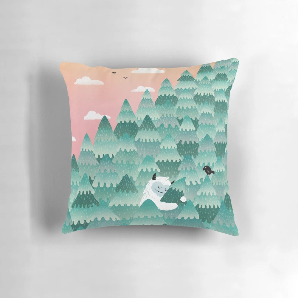 A cozy and whimsical tree hugger pillow featuring a forest-dwelling monster or yeti creature in a picturesque sunrise setting.