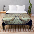 Cozy plush blanket featuring a tree of music design with notes and nature elements
