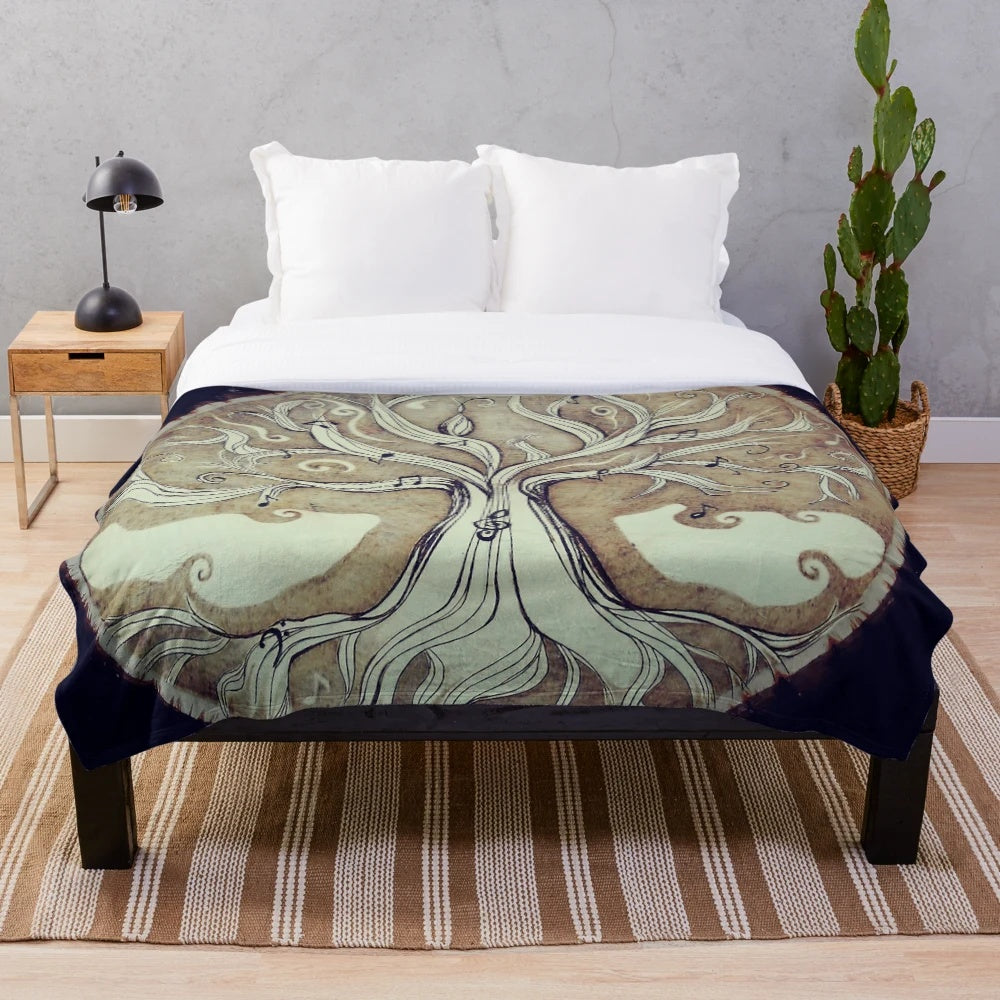 Cozy plush blanket featuring a tree of music design with notes and nature elements