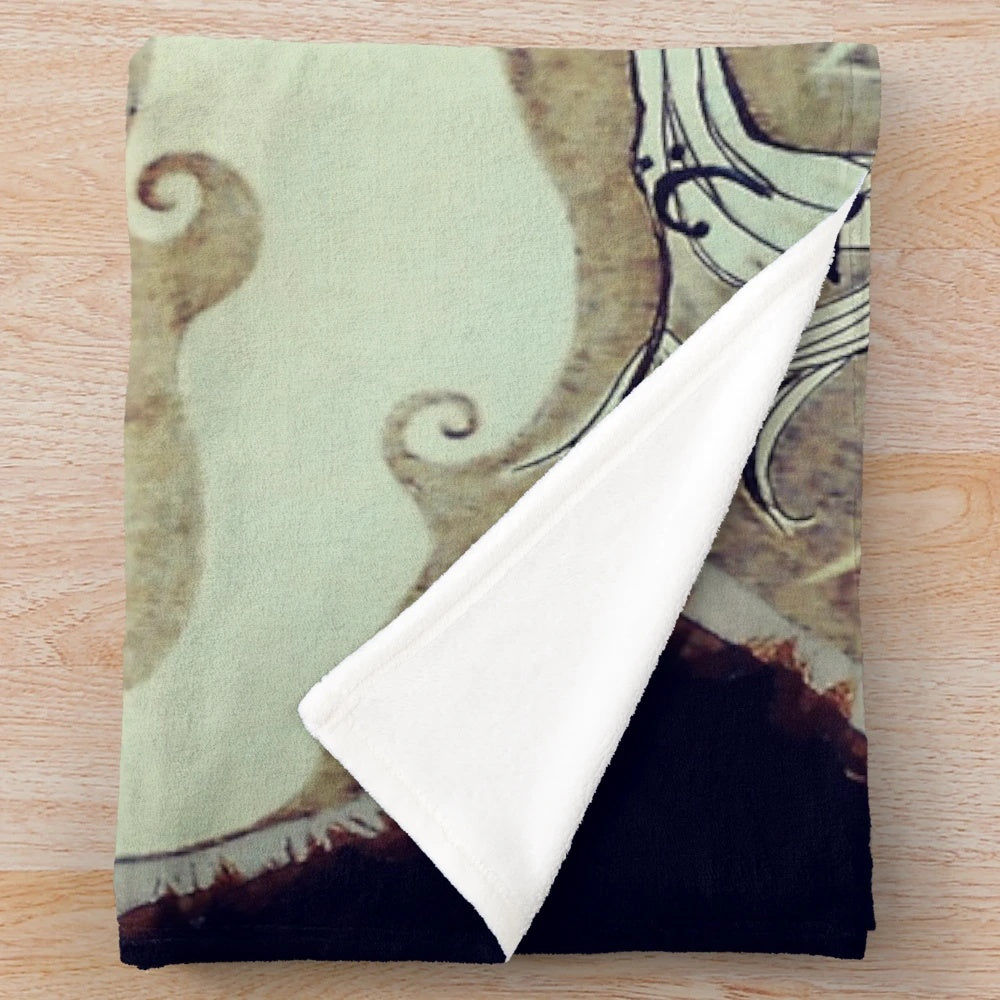 Cozy plush blanket featuring a tree of music design with notes and nature elements