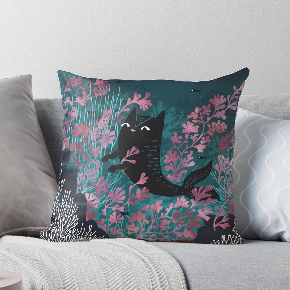 Watercolor illustration of a whimsical mermaid cat creature floating in an underwater landscape on a plush pillow